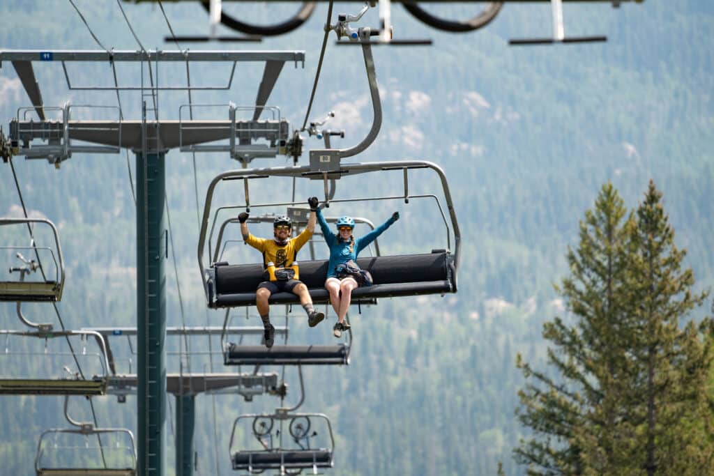 A couple rides the lift before mountain biking