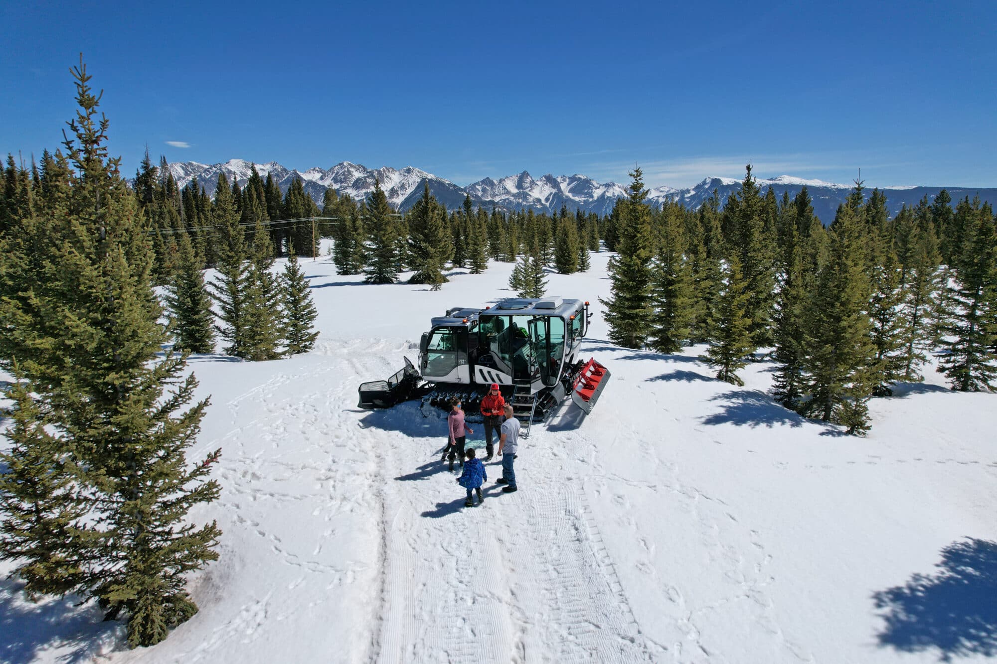 Family steps out of the snowcat after a ride to a great overlook point of the the Needles range