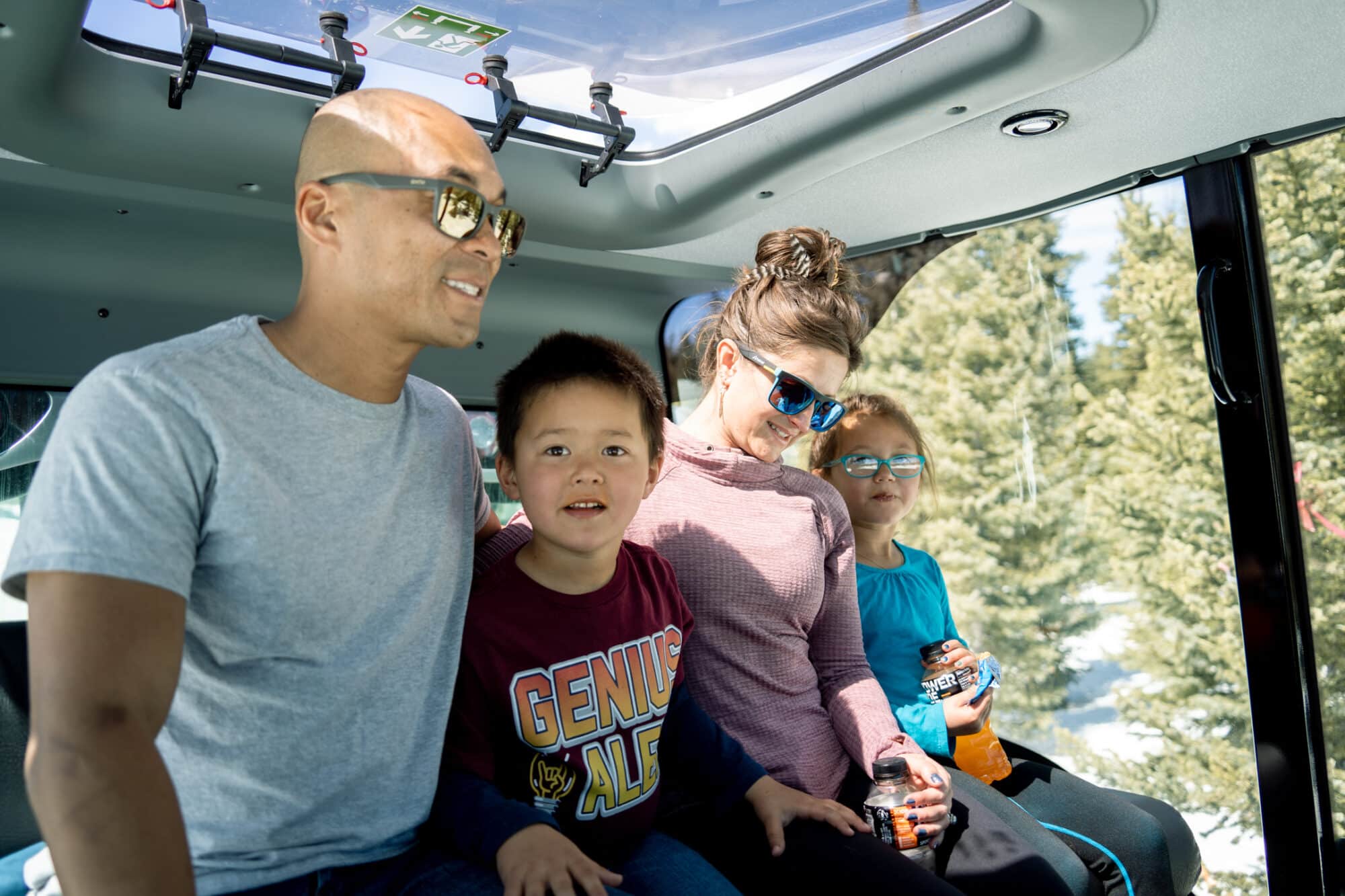 Family rides in luxury in the passenger cabin of the scenic snowcat