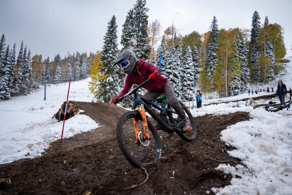 Collegiate rider test the duel slalom course while snow starts falling on the course.