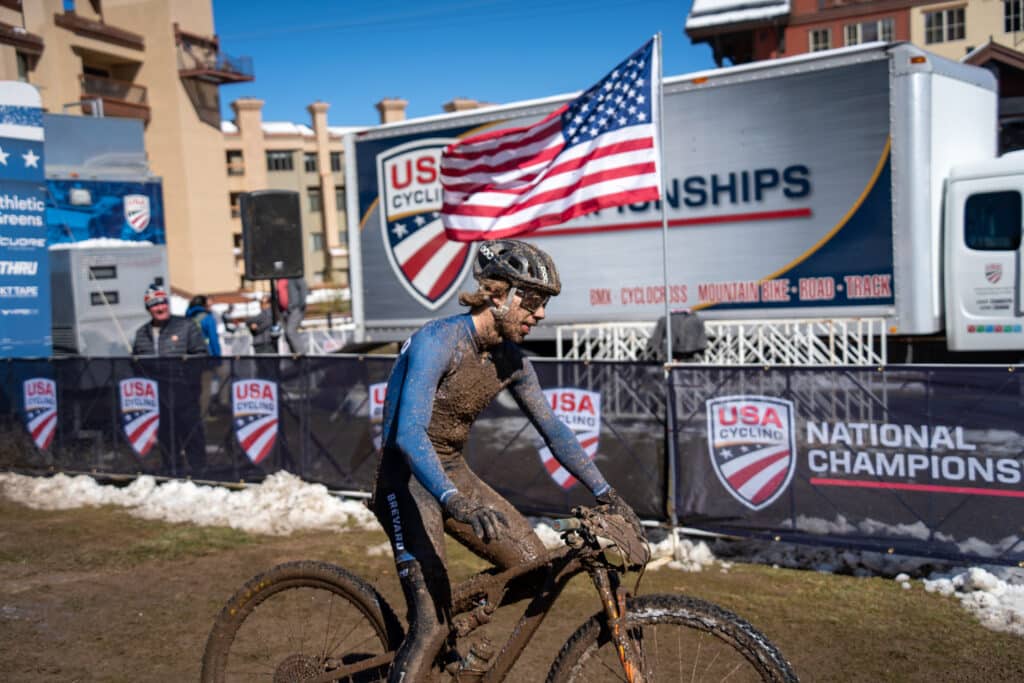 Brevard College athlete rides past the finish line after a grueling race through challenging conditions.