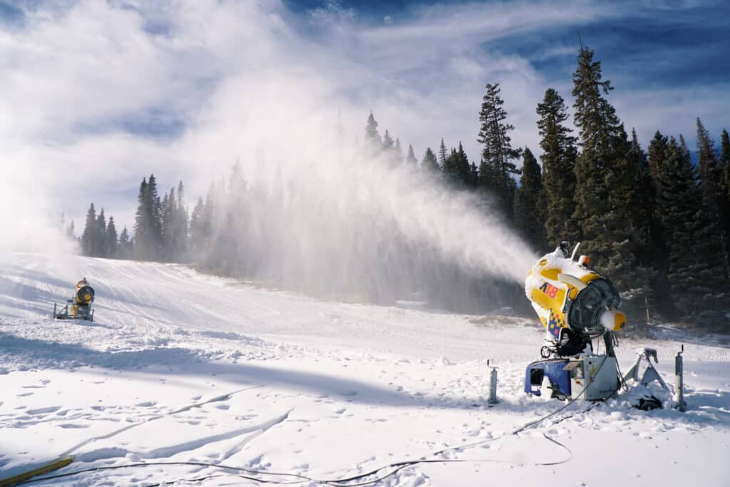 Snowmaking machine spraying snow