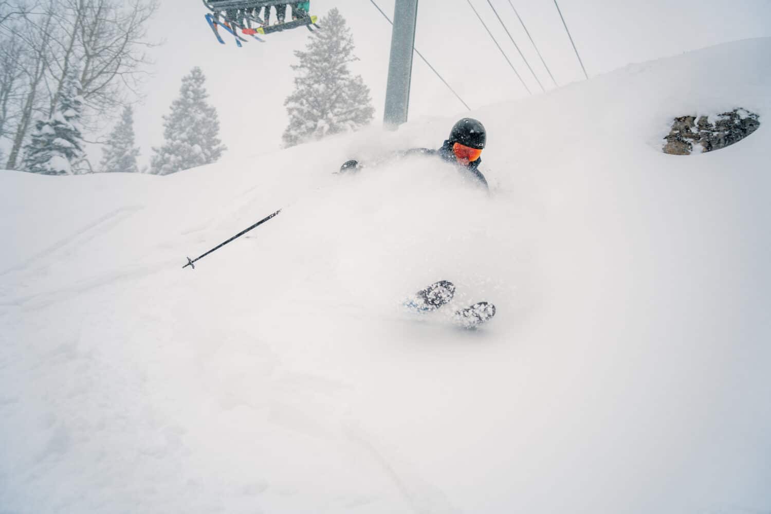 Skier turning in deep powder