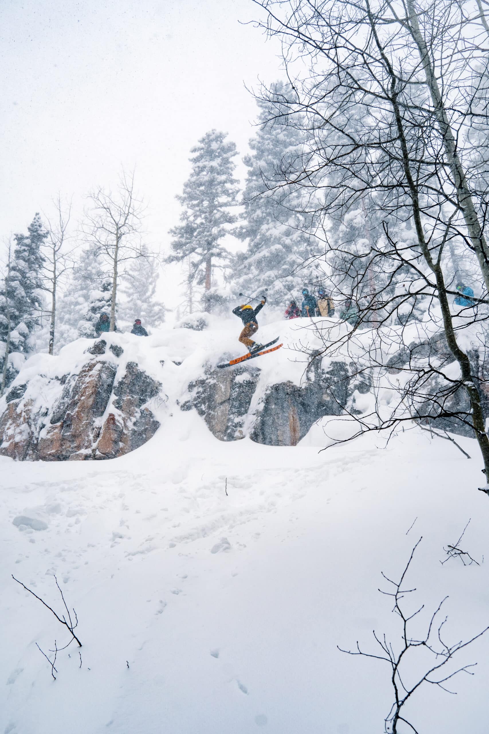 Skier dropping a cliff on a powder day