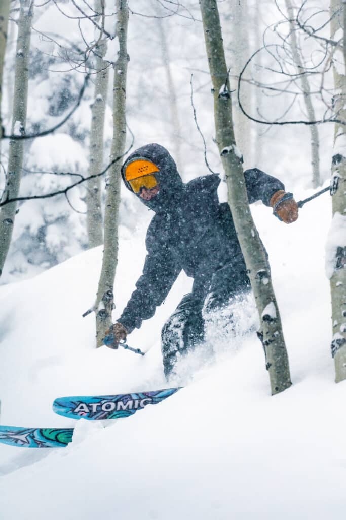 Skier enjoys powder turns through aspen trees