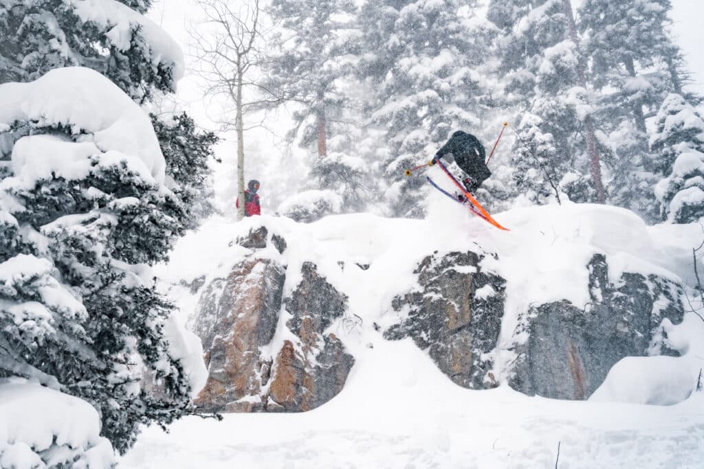 powder skiing off a cliff