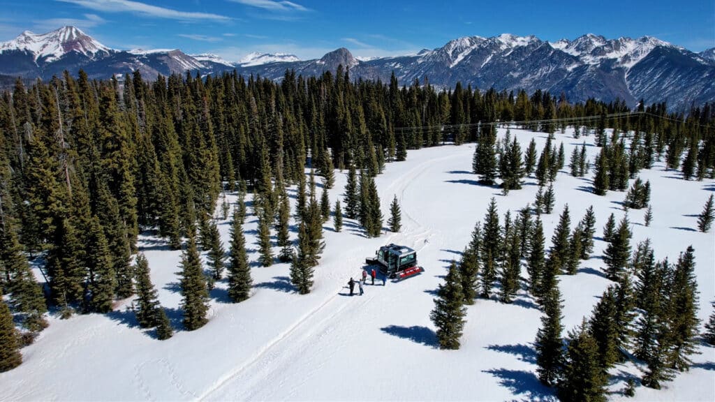 Drone snapshot of the scenic snowcat parked at a incredible overlook of the beautiful San Juan Mountains