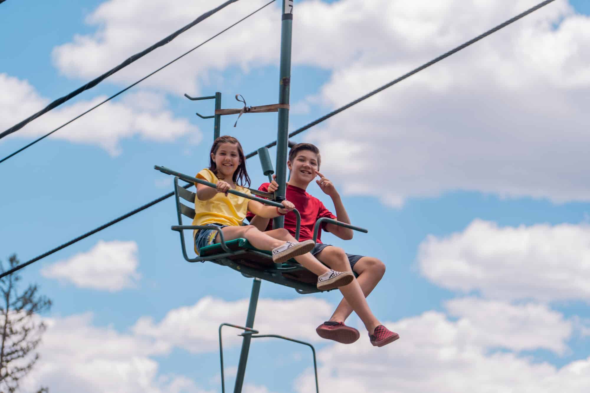 Kids take lift ride up to the top of the alpine slide