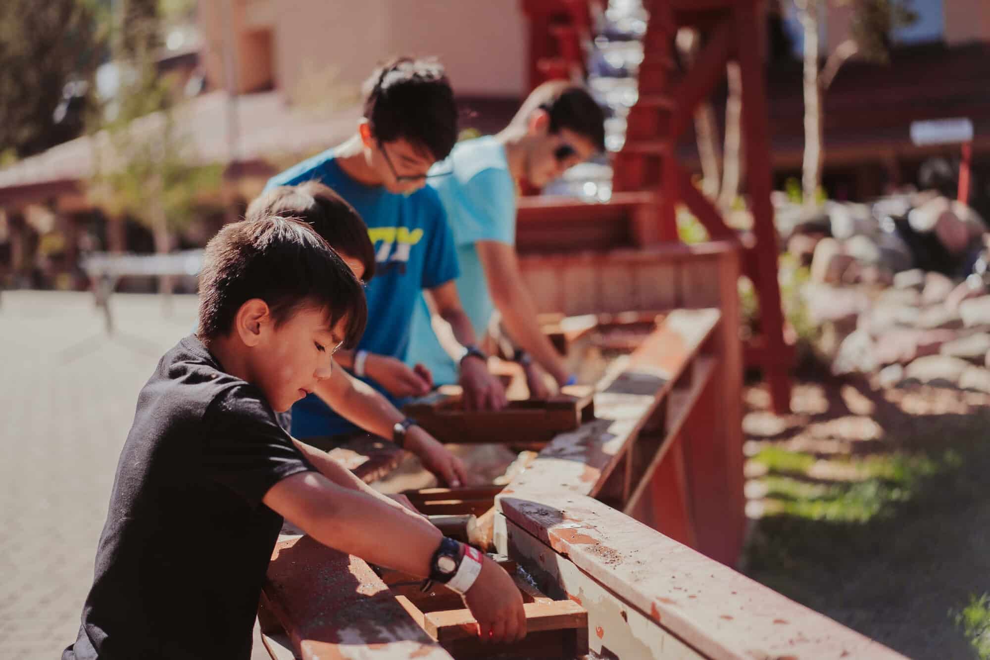 Brothers sift out the sand and dirt as they discover hidden treasures