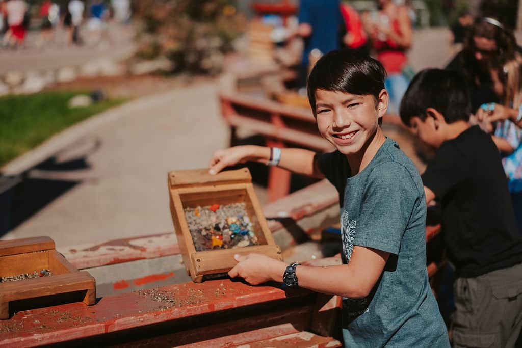 Young boy shows off his collection of gems and treasures