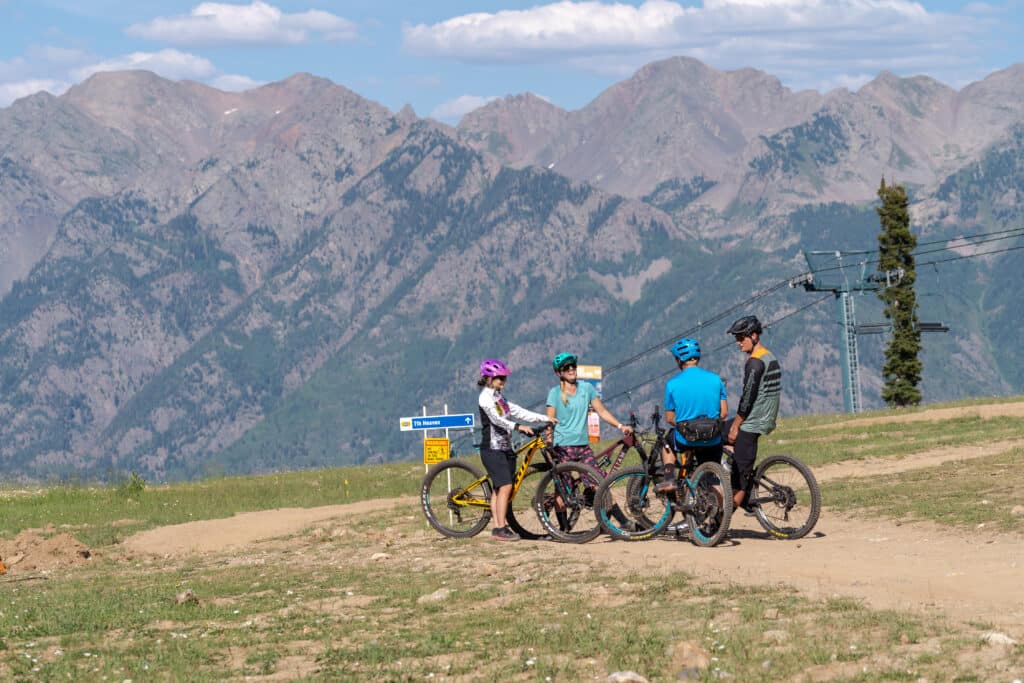 Group of mountain bike rider meet up half way down the trail