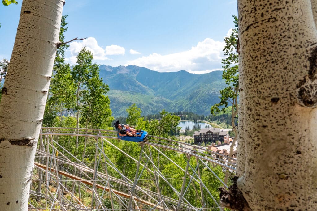 people riding the mountain coaster