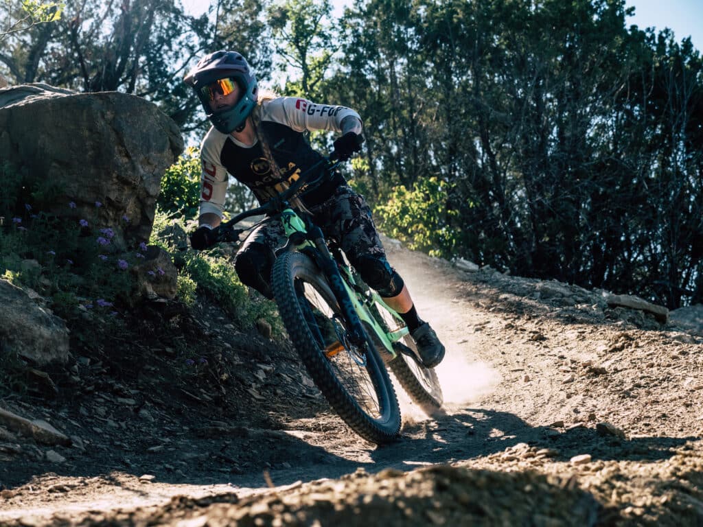 A mountain biker rides her bike at Spider Mountain Bike Park