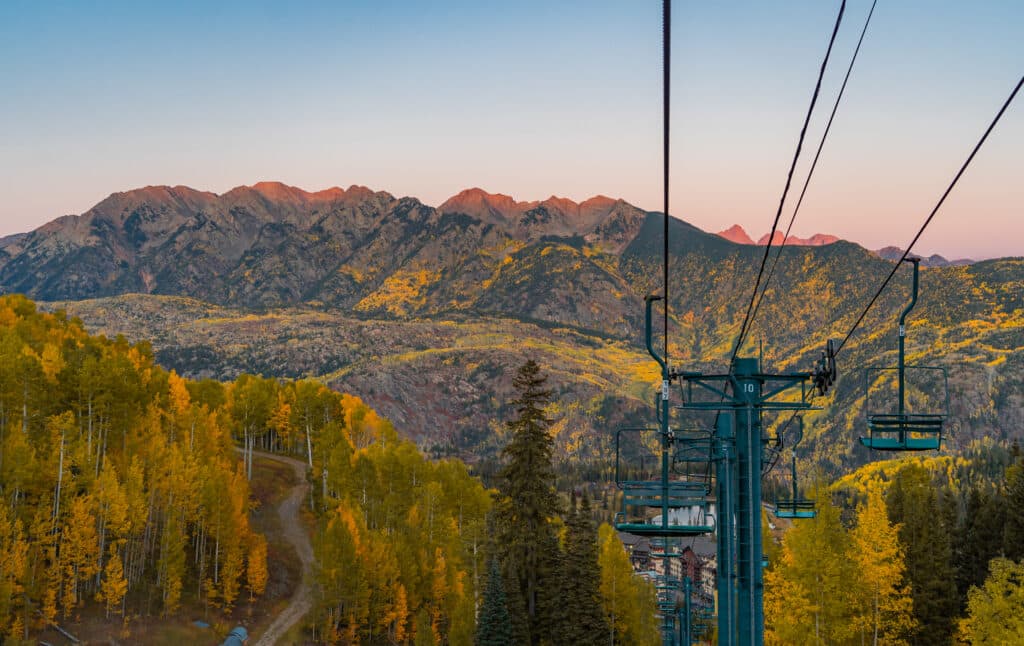 The alpenglow casts a soft evening light on the changing leaves on a fall evening