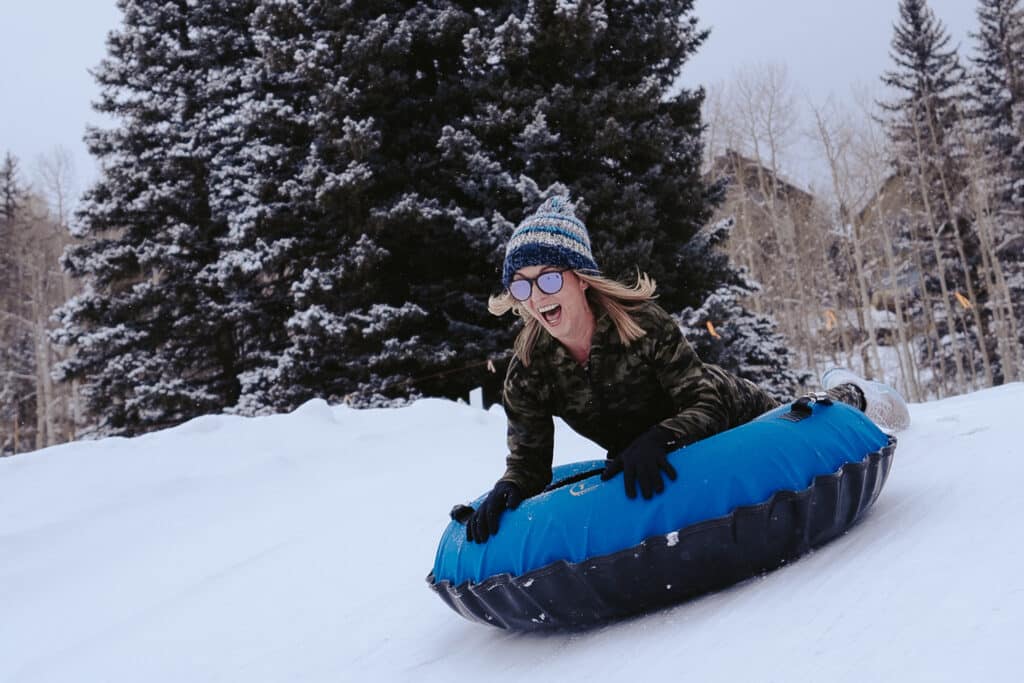 Female drops in at the top of the tubing hill