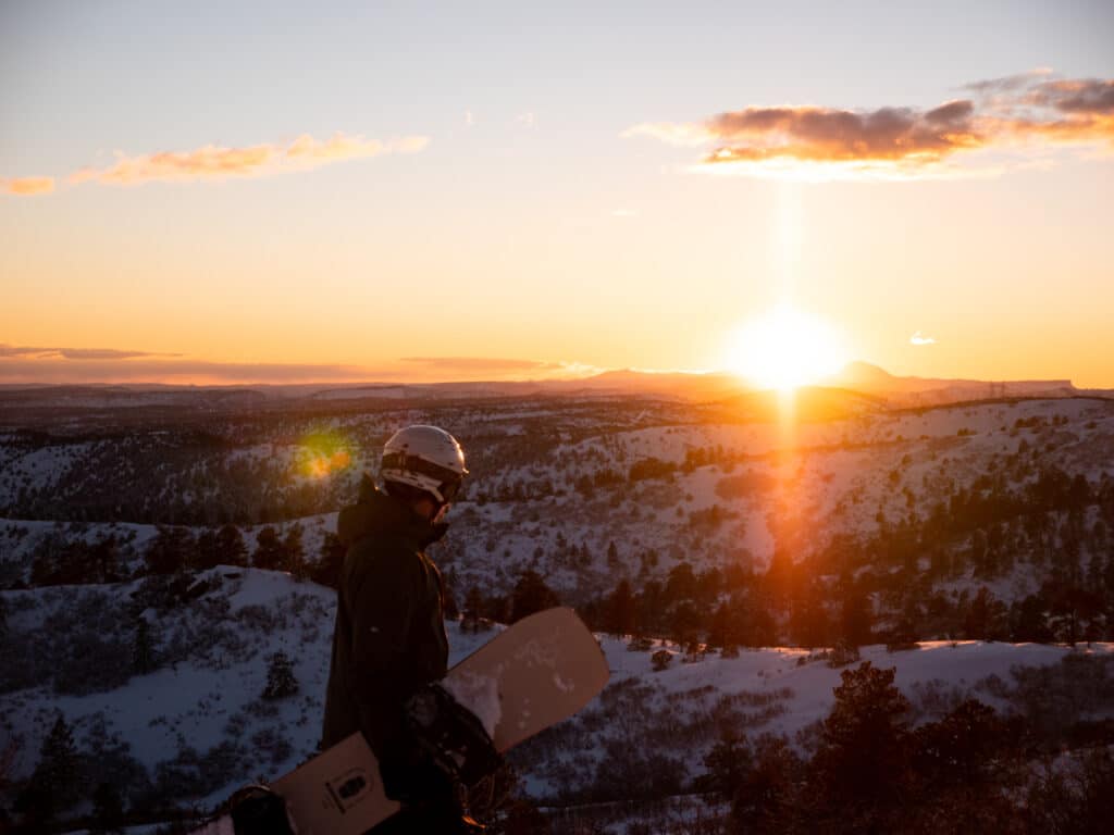 Snowboarder watching the sunset at Hesperus