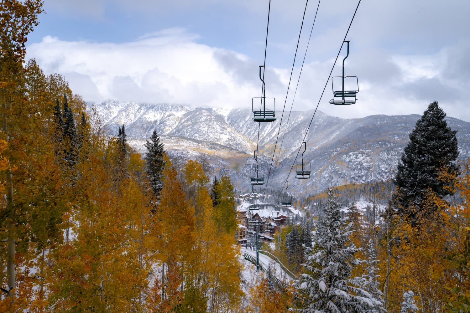 Views of snowy peaks and bright fall aspens from halfway up lift 4