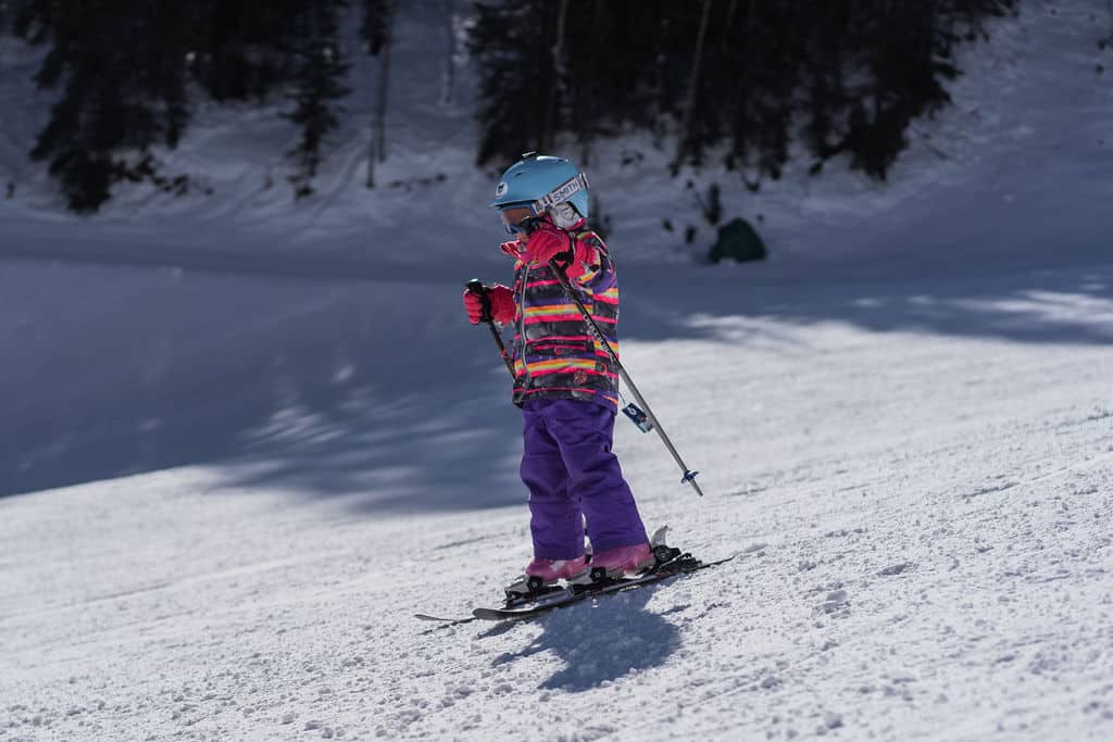 Young skier rides down the mountain