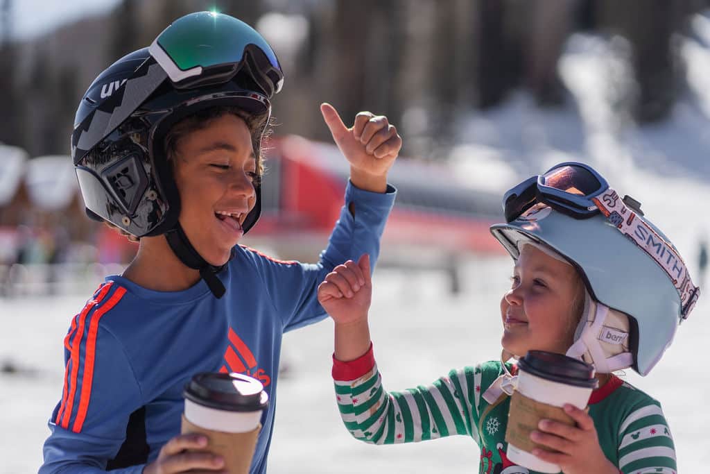 Brother and sister enjoy hot chocolate break at the beach area
