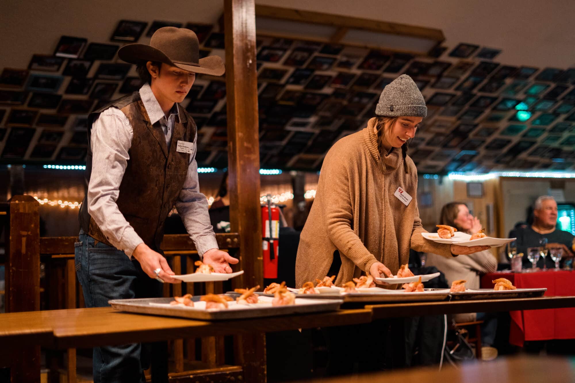 Employees passing out plates to guests