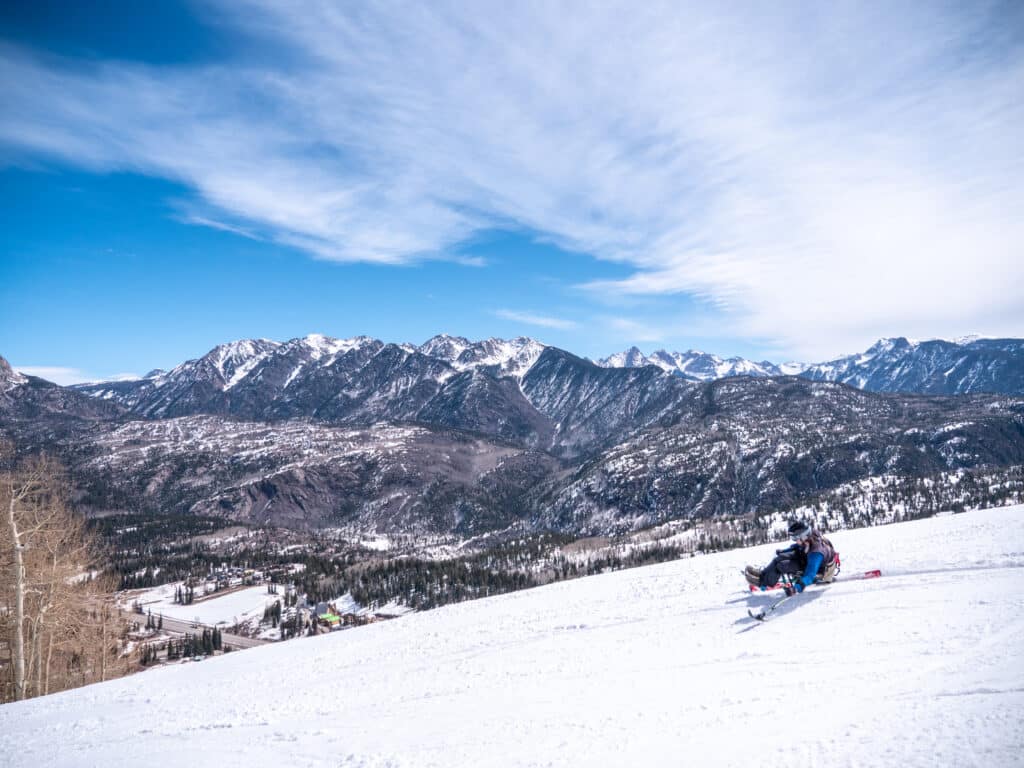 Adaptive skier takes turn on a mono chair ski