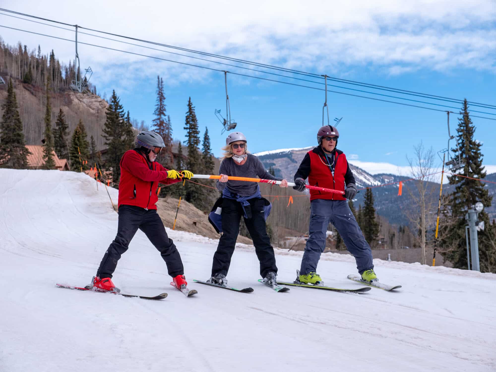 Adaptive instructors guide student using a balance bar