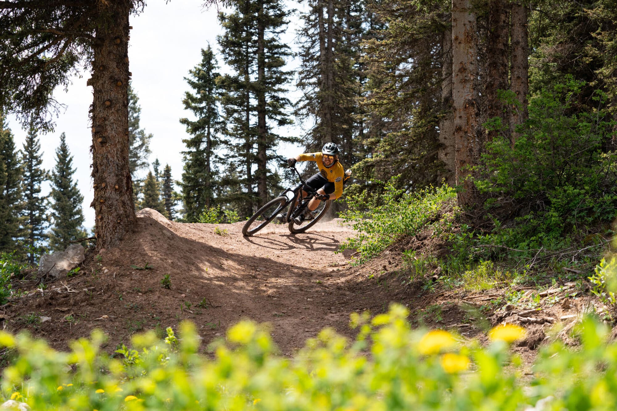 Mountain biker rides a berm on the Shangri-La trail