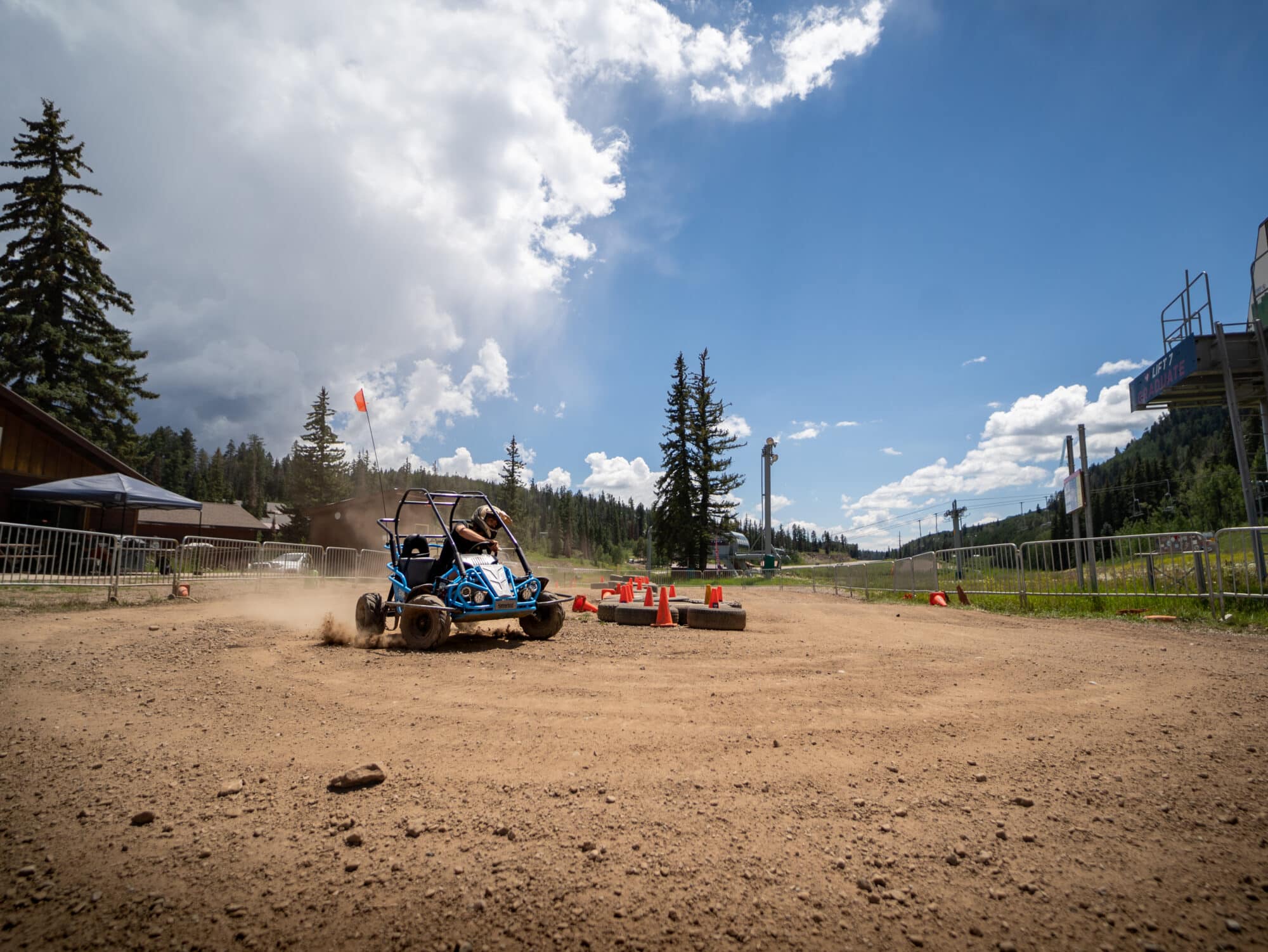 Driver races around the corner turn kicking up dust