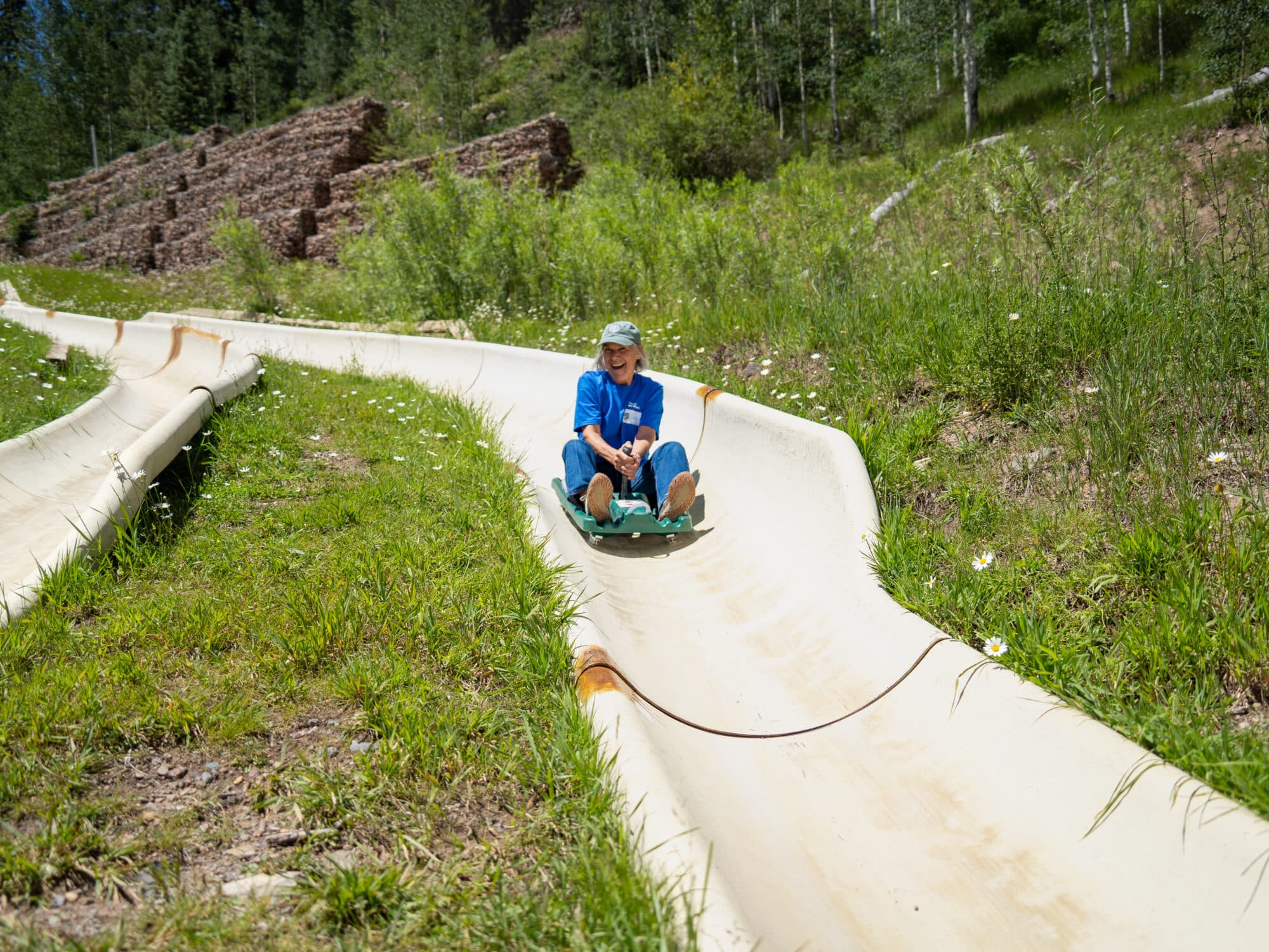 Alpine slide rider grins as she races down the track