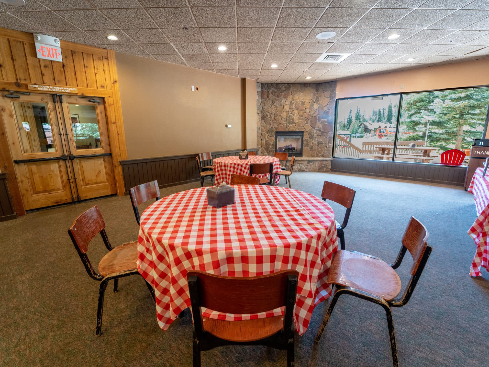 Red checkered tablecloth's cover the tables inside Hoody's Basecamp