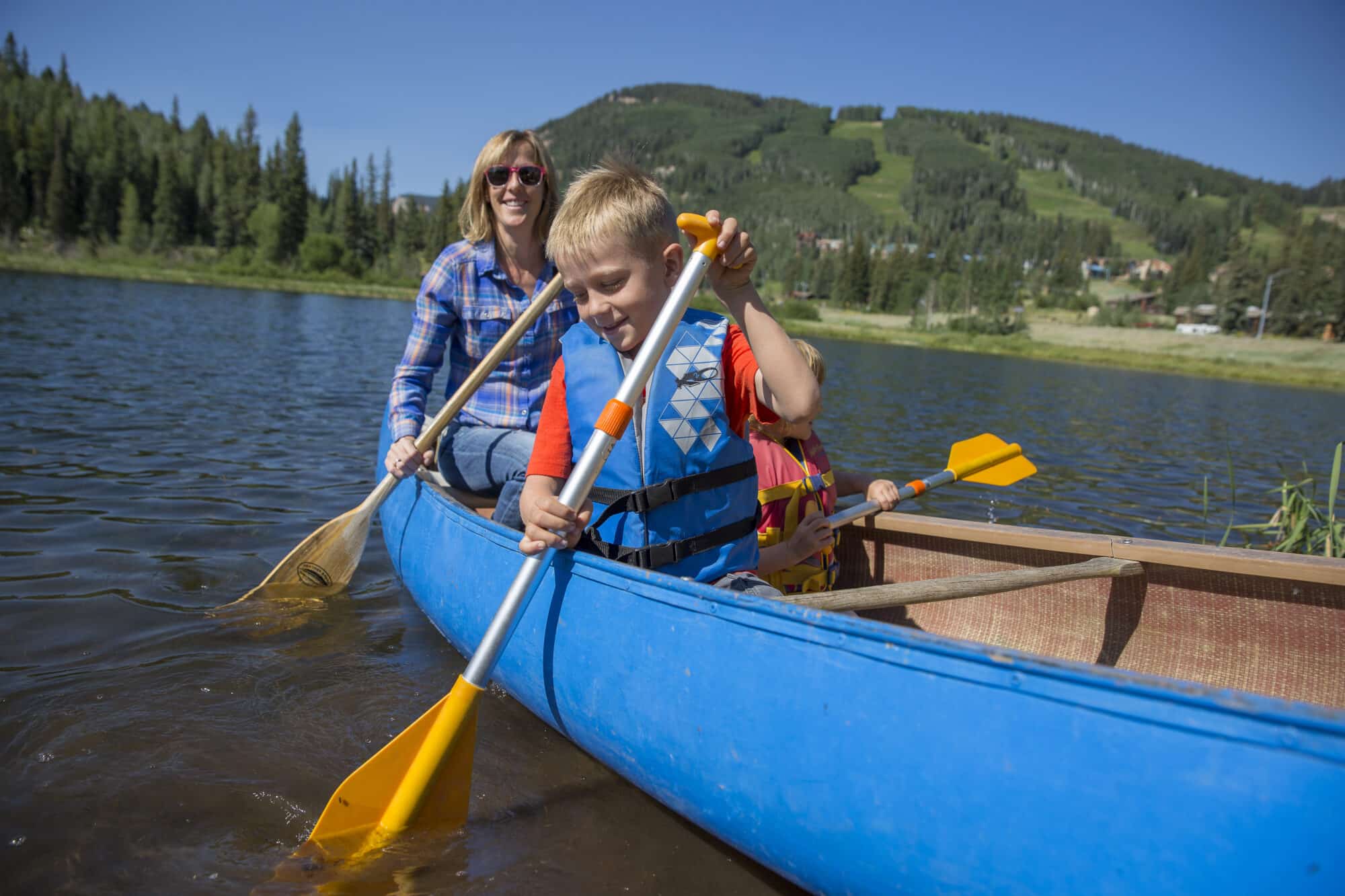 Family Canoes at Twilight Lake on a hot summer day