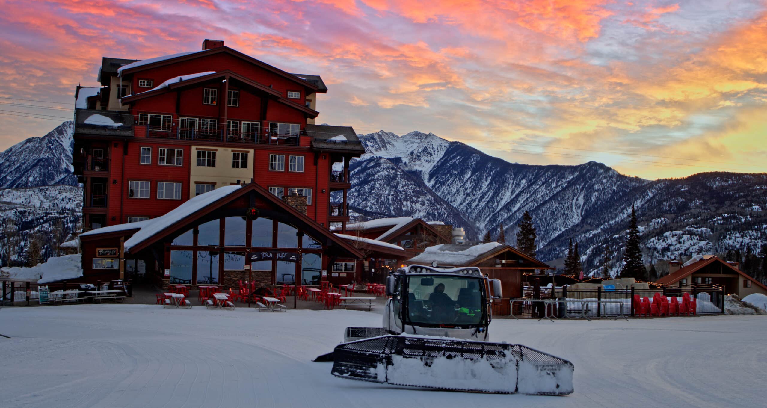 Snowcat driver finishes his shift under a beautiful mountain sunrise