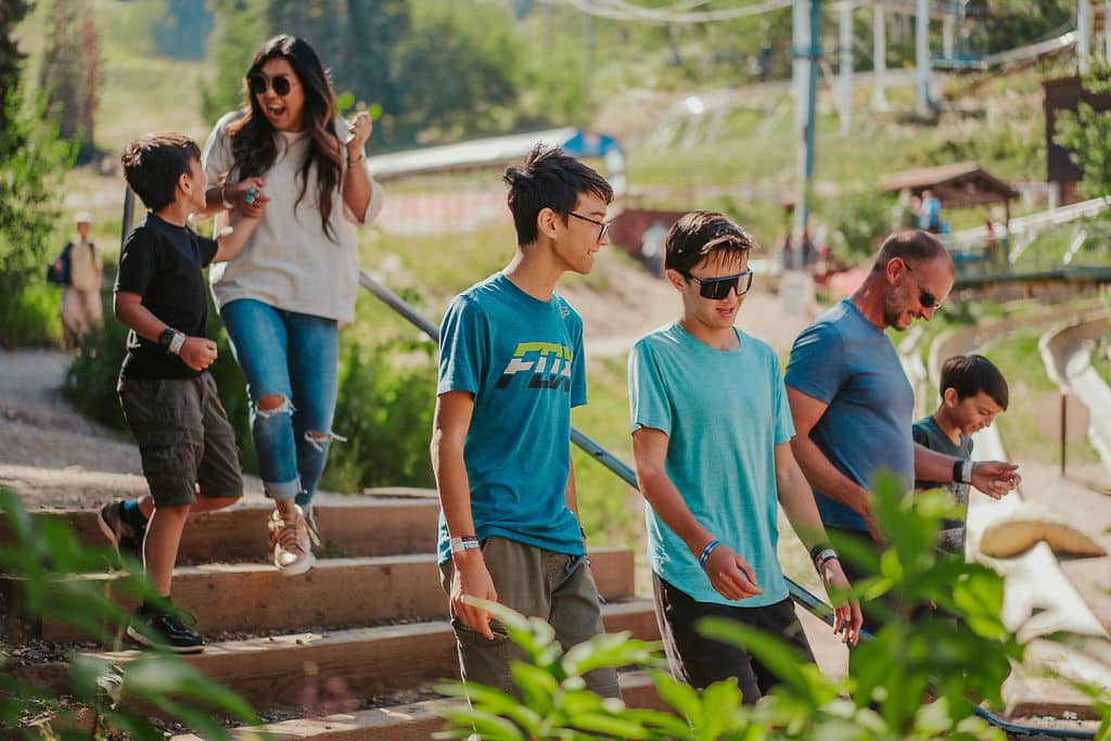 Family exits the alpine slide with huge smiles on their faces