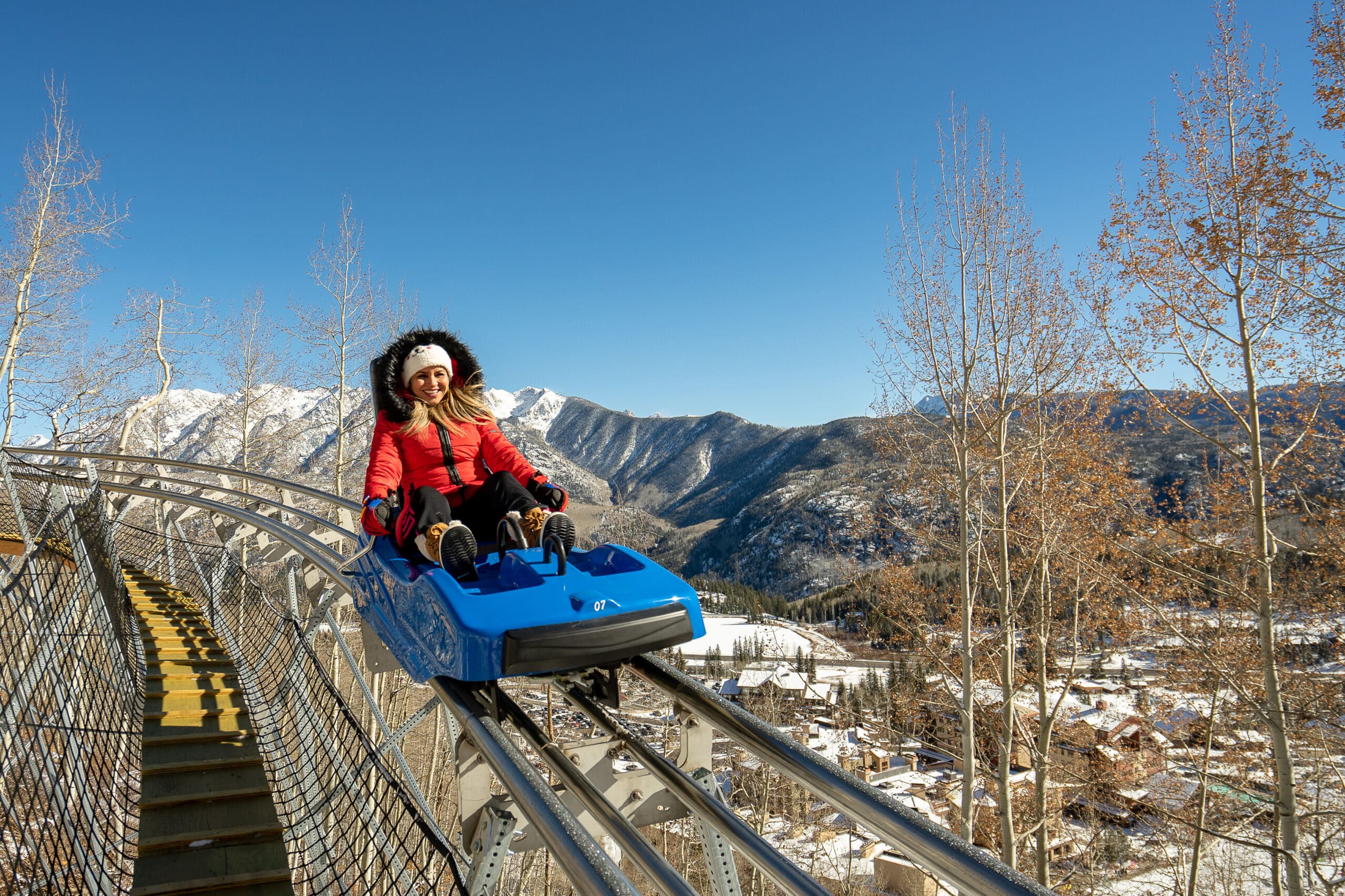 Female enjoys the crisp alpine air while riding the Inferno Mountain Coaster