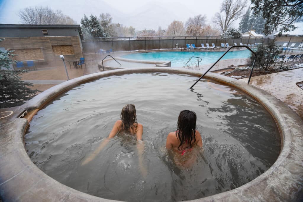 2 people relaxing at the Durango hot springs