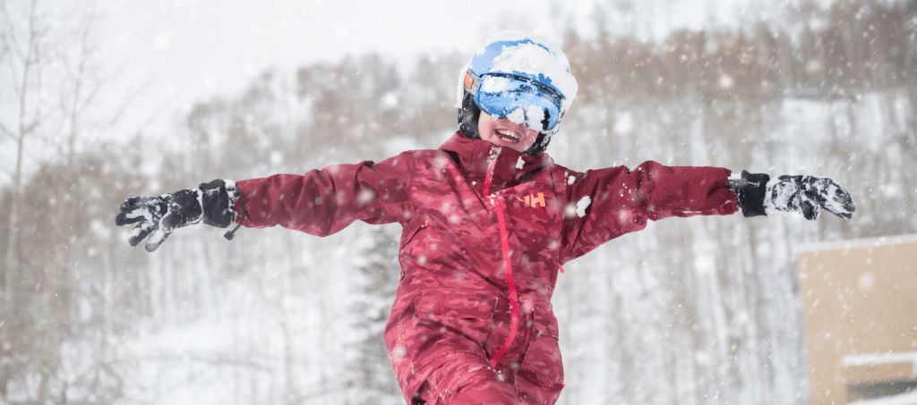 kid playing in the snow