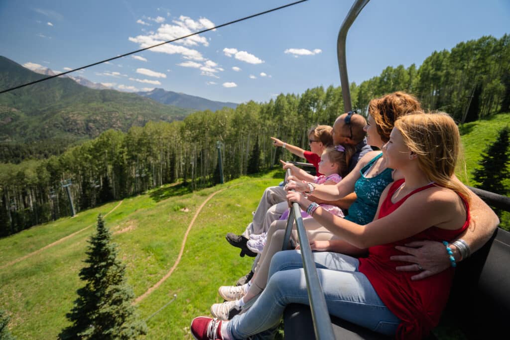 Family riding down the scenic chairlift