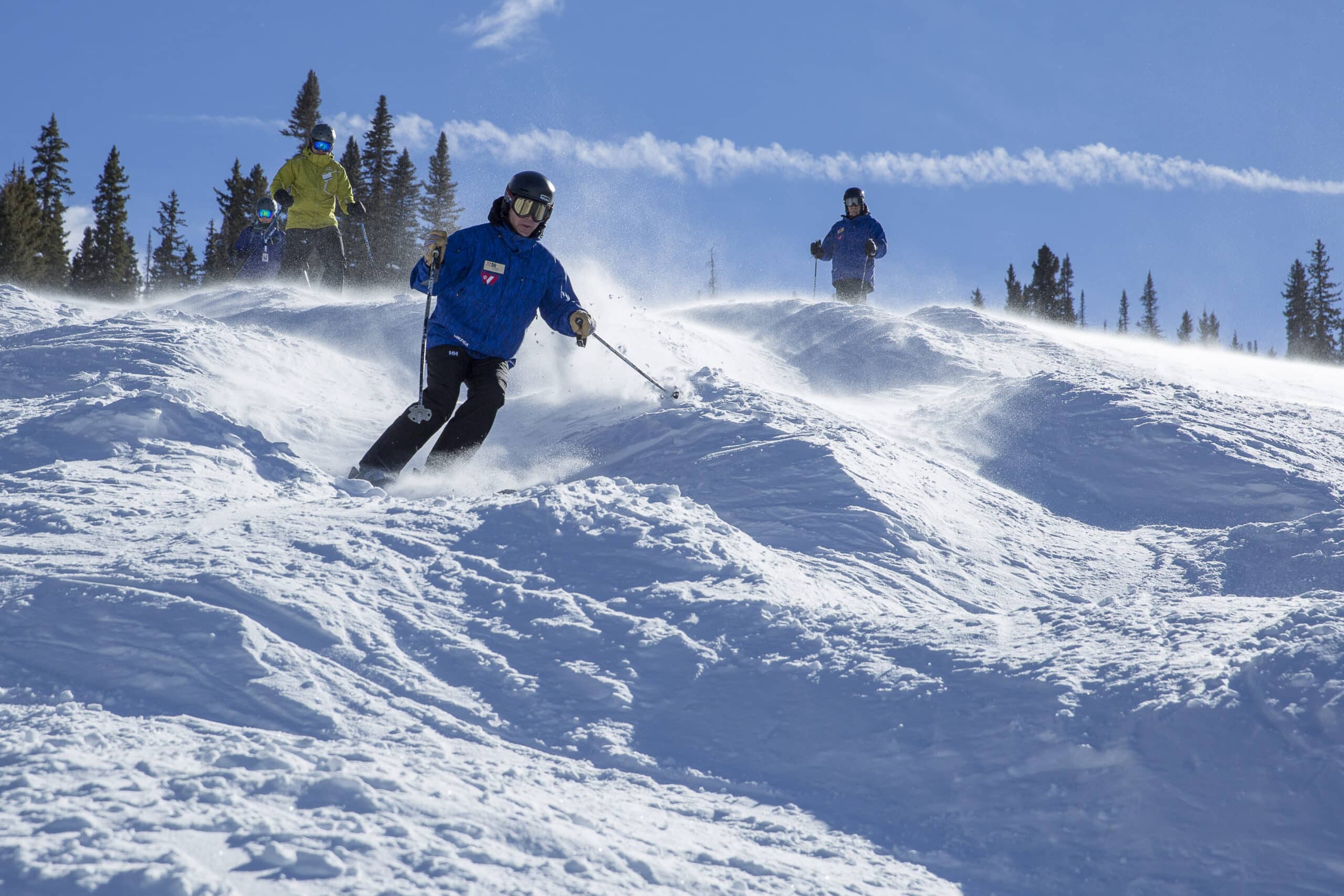 Mens group lessons learns how to ski moguls