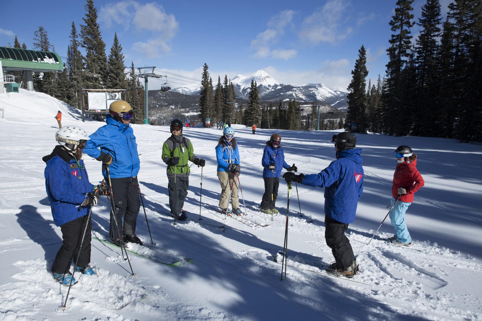 Adult group lesson meets at the top of the Purgatory Express lift