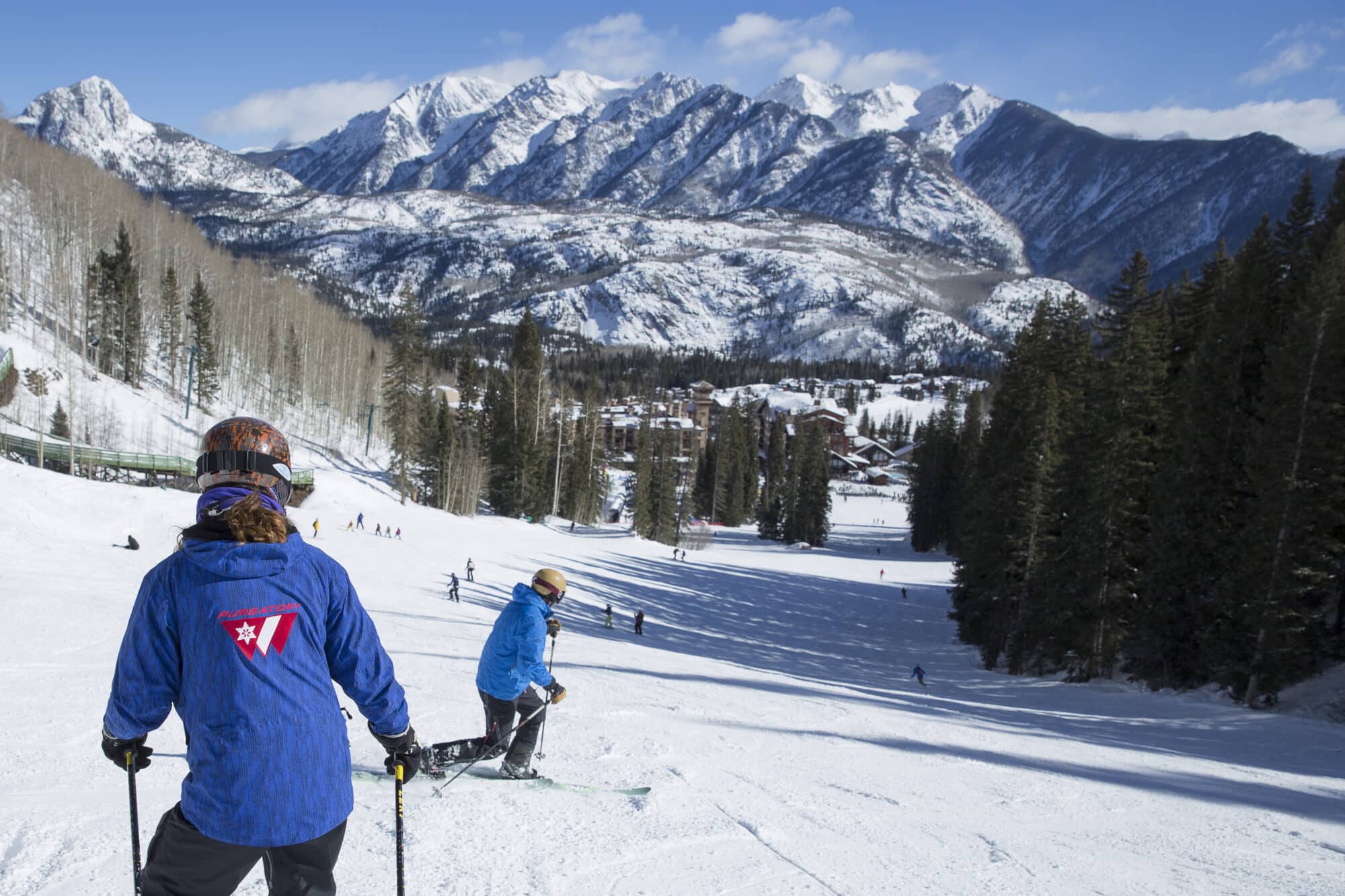 Telemark ski instructor follows student down lower demon during a private lesson