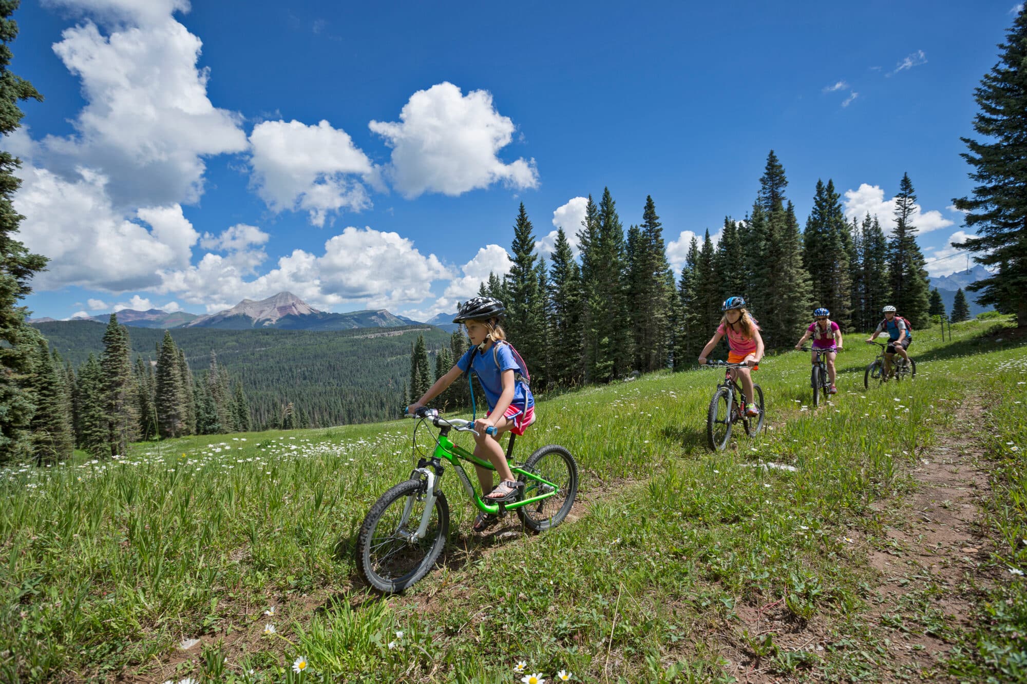 Family with young girls rides mountain bikes at Purgatory Resort