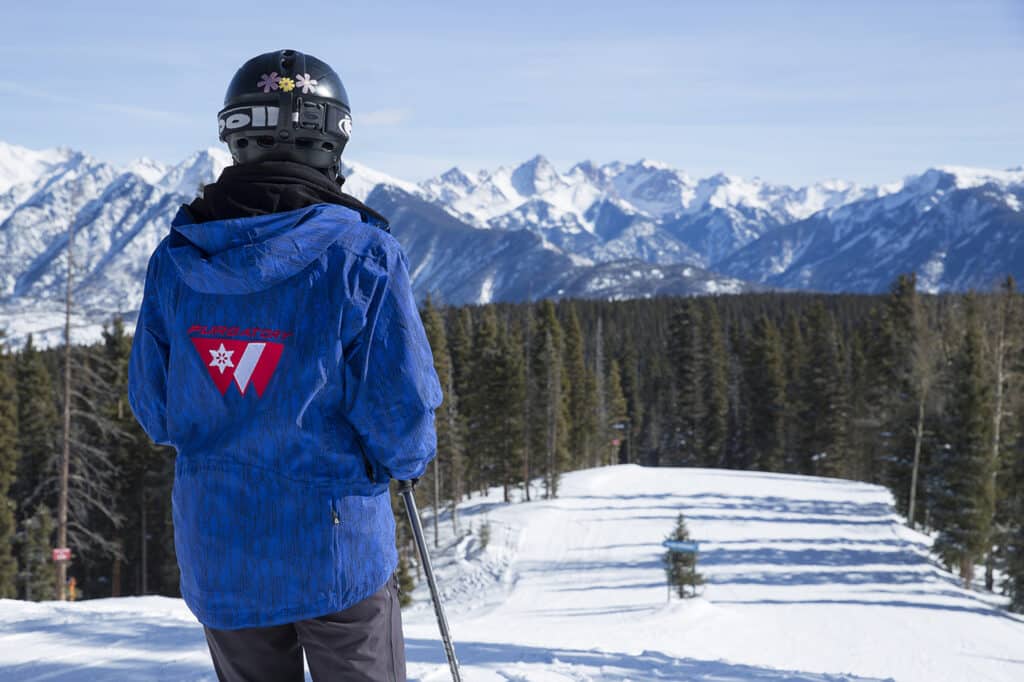 Ski school instructor looking at the majestic Needles Mountain Range