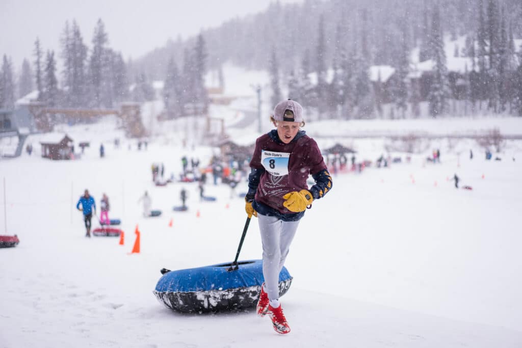 Your racer pulls his tube up the hill at the Uncle Clyde's Run and Slide