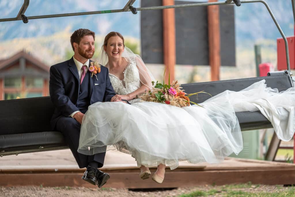 Bride and groom sit on the Purgatory Express lift