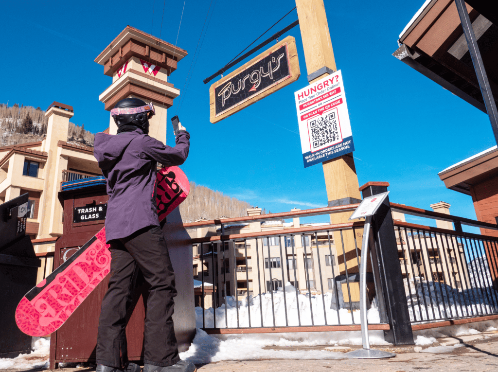 Woman scanning qr code for online food ordering