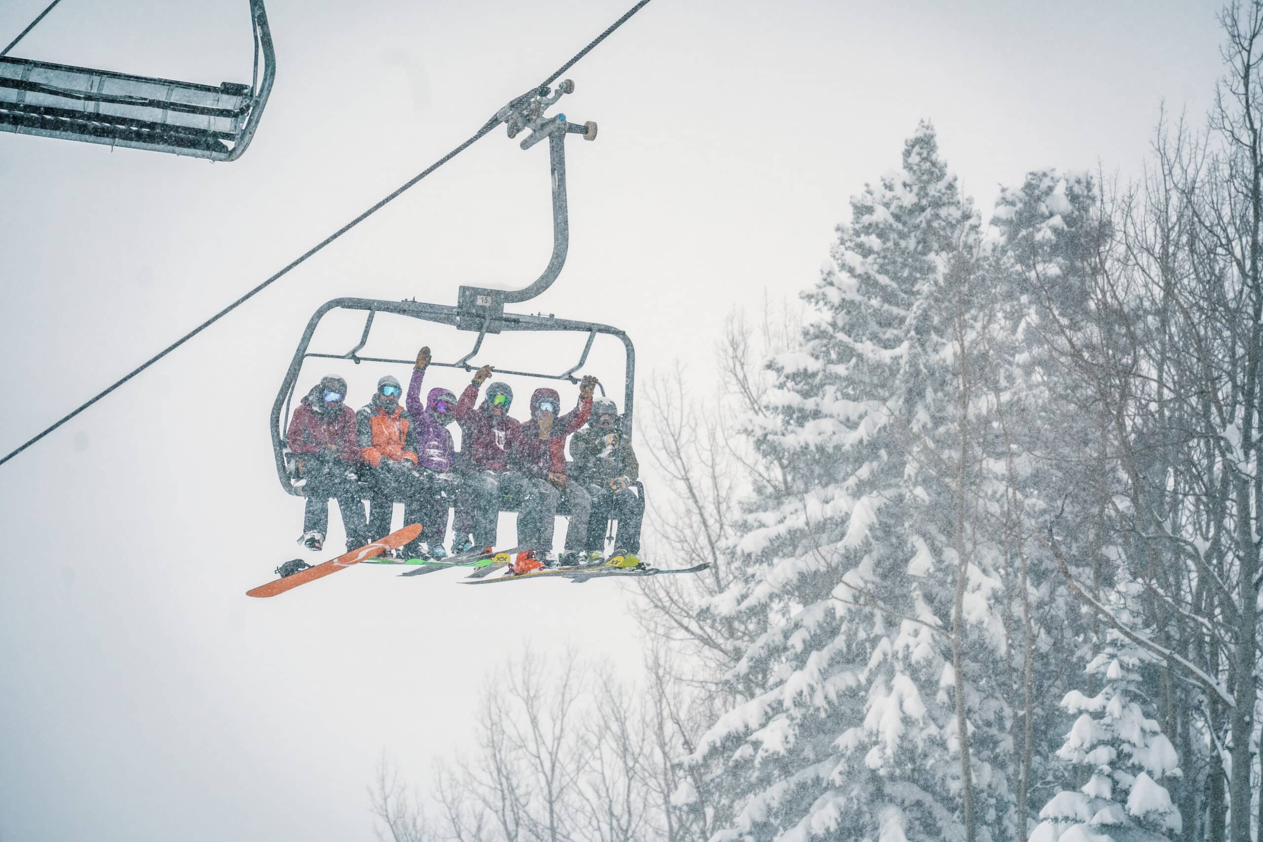 Friends ride the lift together on a powder day