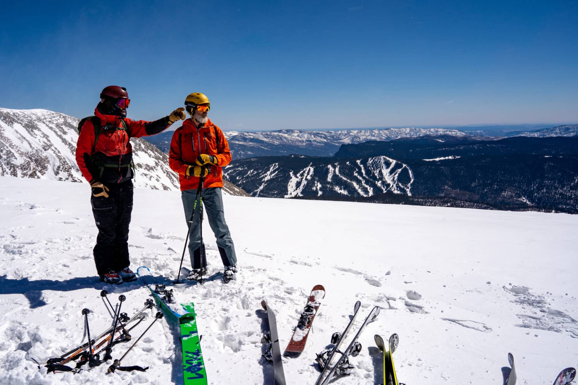 Snowcat guide points out peaks on top of Grayrock Peak with Purgatory Resort in the distance