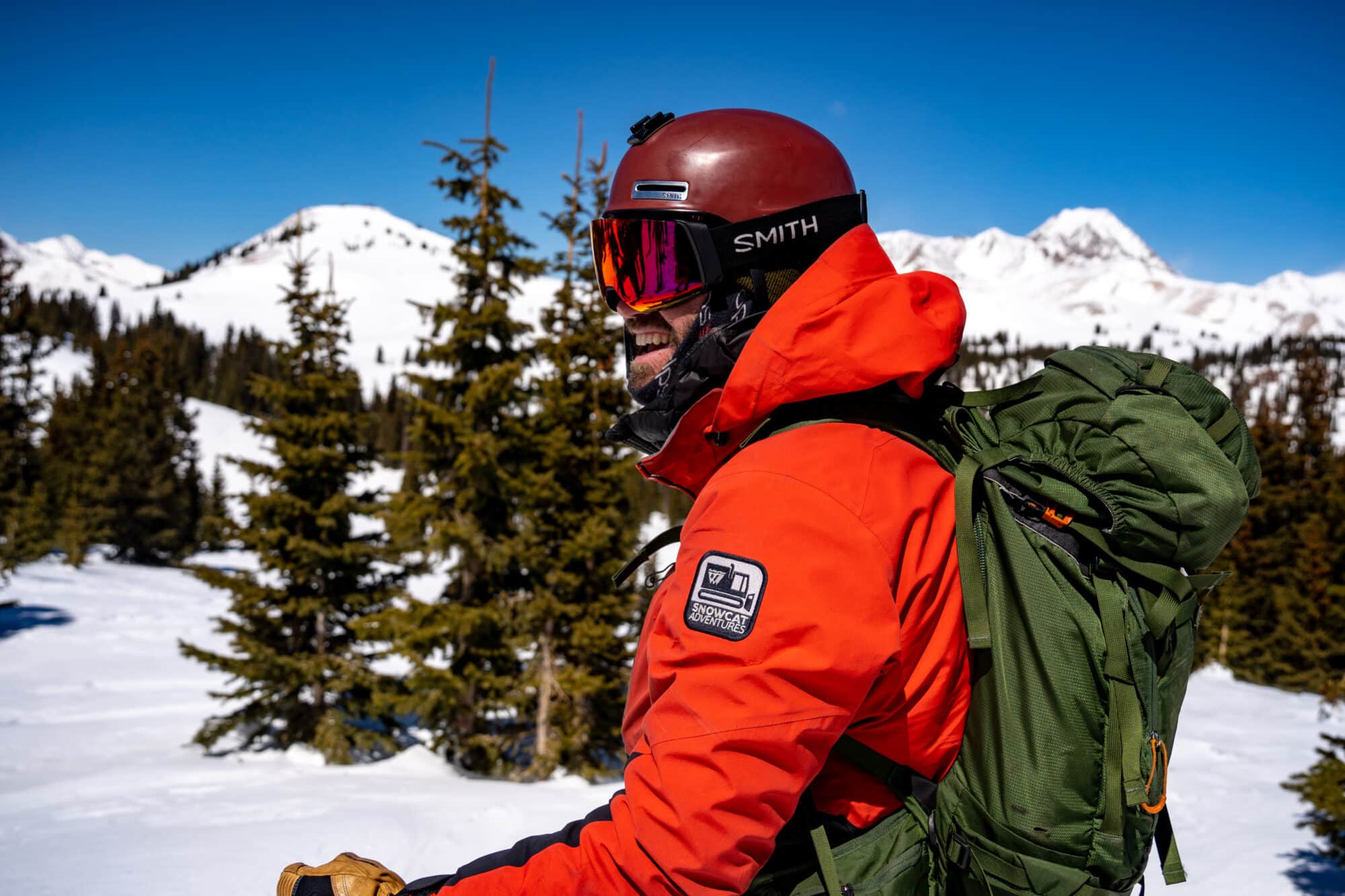 Snowcat skiing guide gives instructions before heading down the first pitch