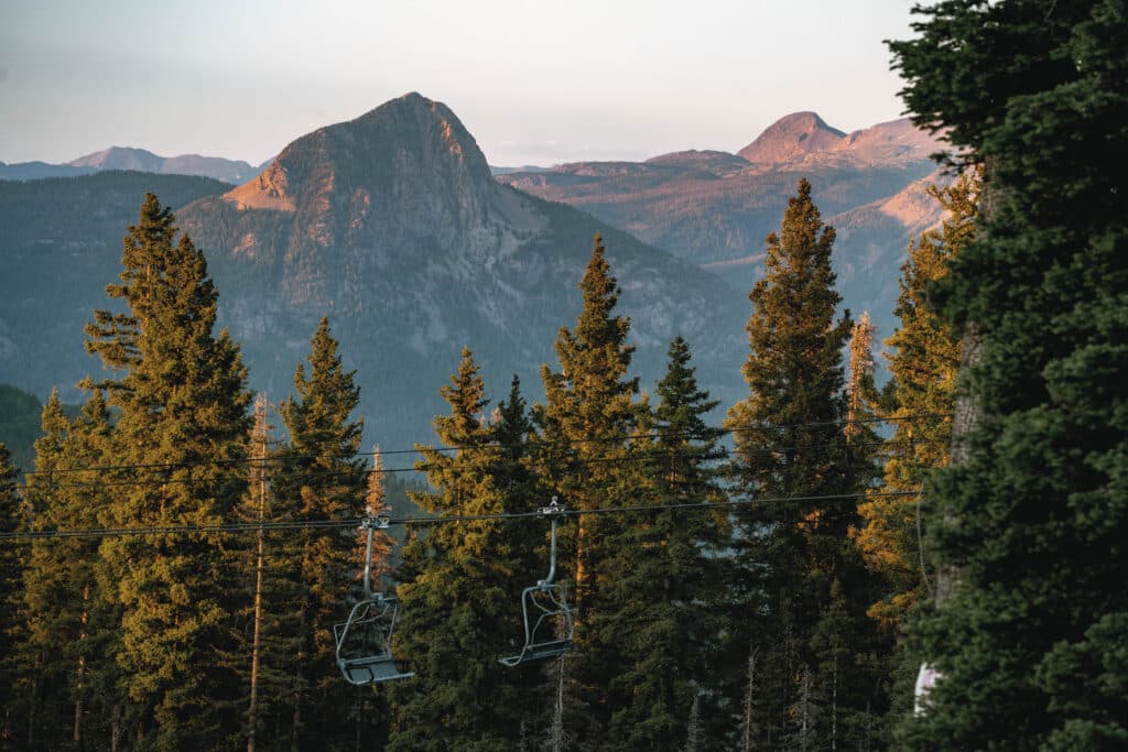 The sun set casts golden light on Spud Mountain as viewed from the chair lift