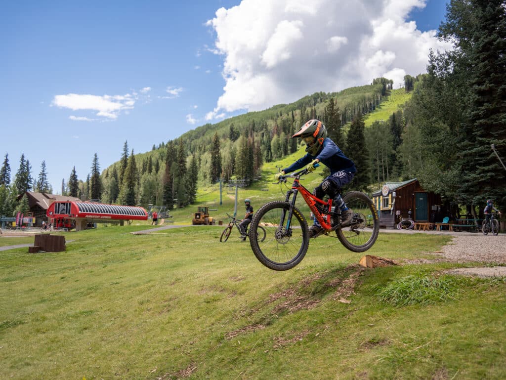 Grommet jumps his bike in the Purgatory base area